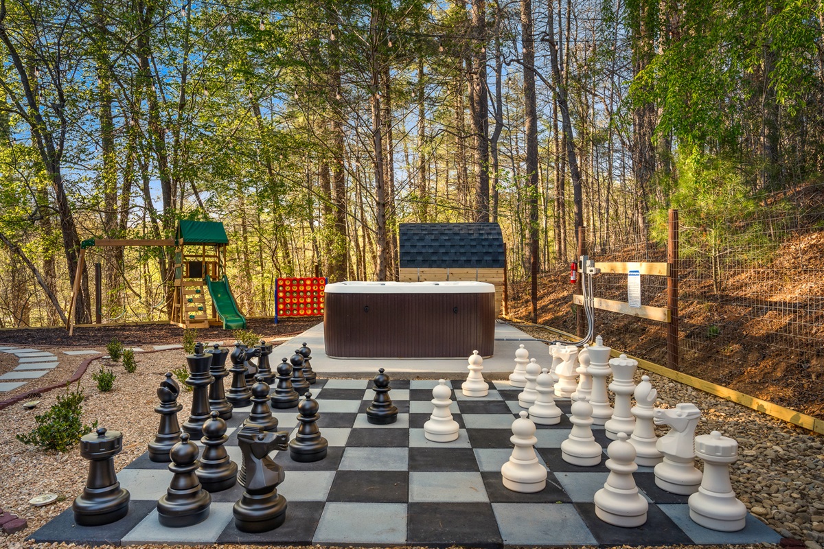 Backyard layout featuring chess, hot tub, and play areas - designed for groups to spread out and enjoy