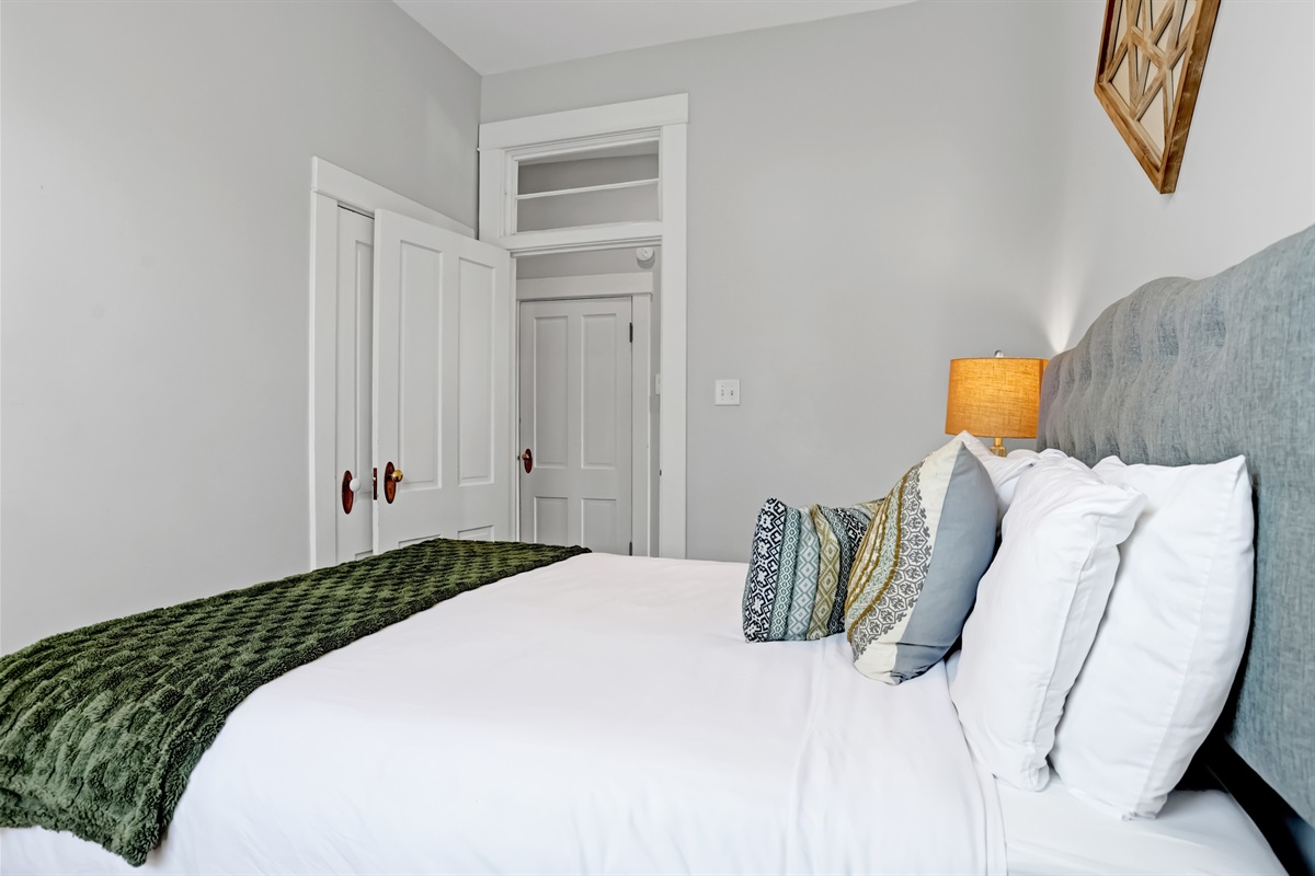A serene bedroom filled with sunlight and comfort.