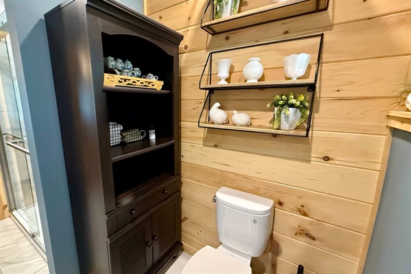 Renovated bathroom with a spacious tile shower, bench, glass enclosure, and modern vanity. Bright, functional, and comfortable.