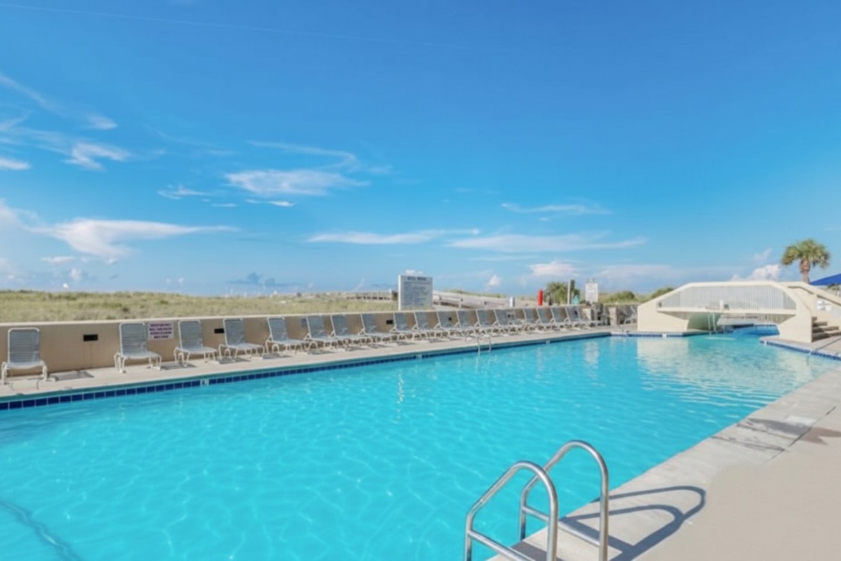 Dive into relaxation at the expansive outdoor pool at Phoenix VI! With plenty of lounge seating and the fresh Gulf breeze, it's the perfect spot to cool off after a day in the sun.
