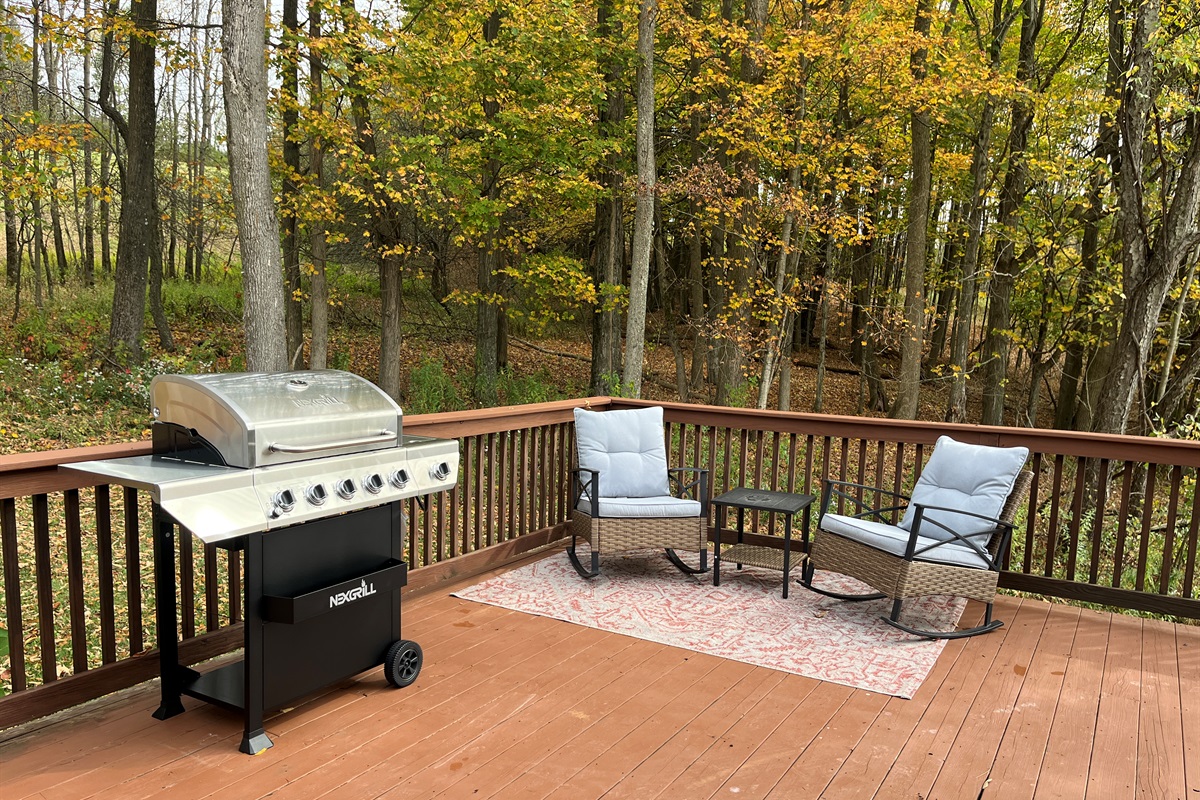 Gas grill and comfy chairs on the deck