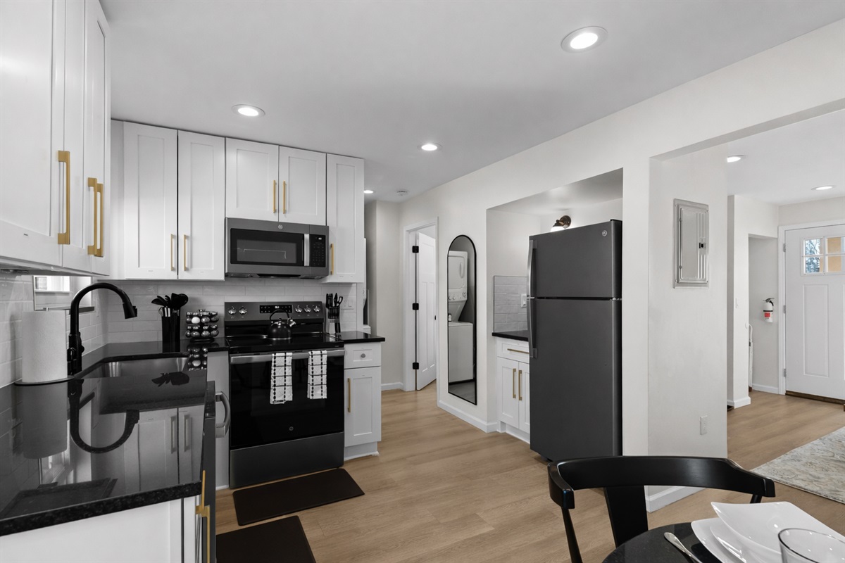 Sleek, modern kitchen with crisp white cabinetry, stainless appliances, and ample counter space—perfect for cooking, hosting, and everyday convenience.