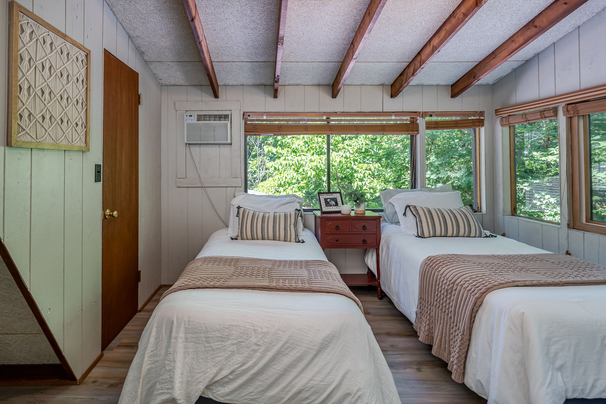 Your second floor bedroom fits four and still feels open — big windows let the light in, and there's room to actually spread out.