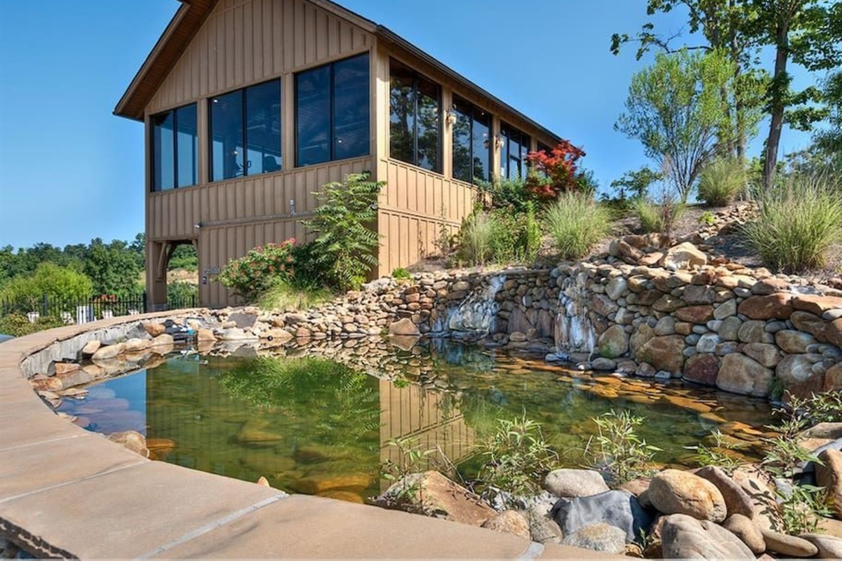 - Scenic pond with stone landscaping and lush greenery all around   - Peaceful water feature creating a calm, nature-inspired atmosphere   - Ideal backdrop for photos or quiet moments surrounded by beauty