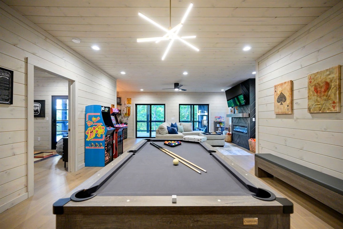 Extra large game room & den feature a pool table w/ping pong table top, poker set, arcade games plus a wet bar w/beverage fridge.  The extra comfortable sectional couch sits in front of a 65" TV and a gorgeous electric fireplace.  