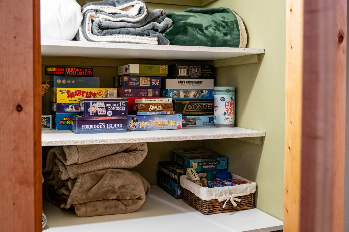 Game closet stocked with board games and indoor entertainment for all ages.