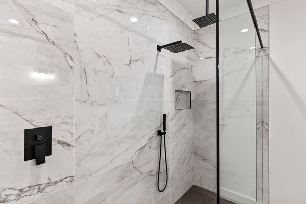 Large walk in shower with dual shower heads.