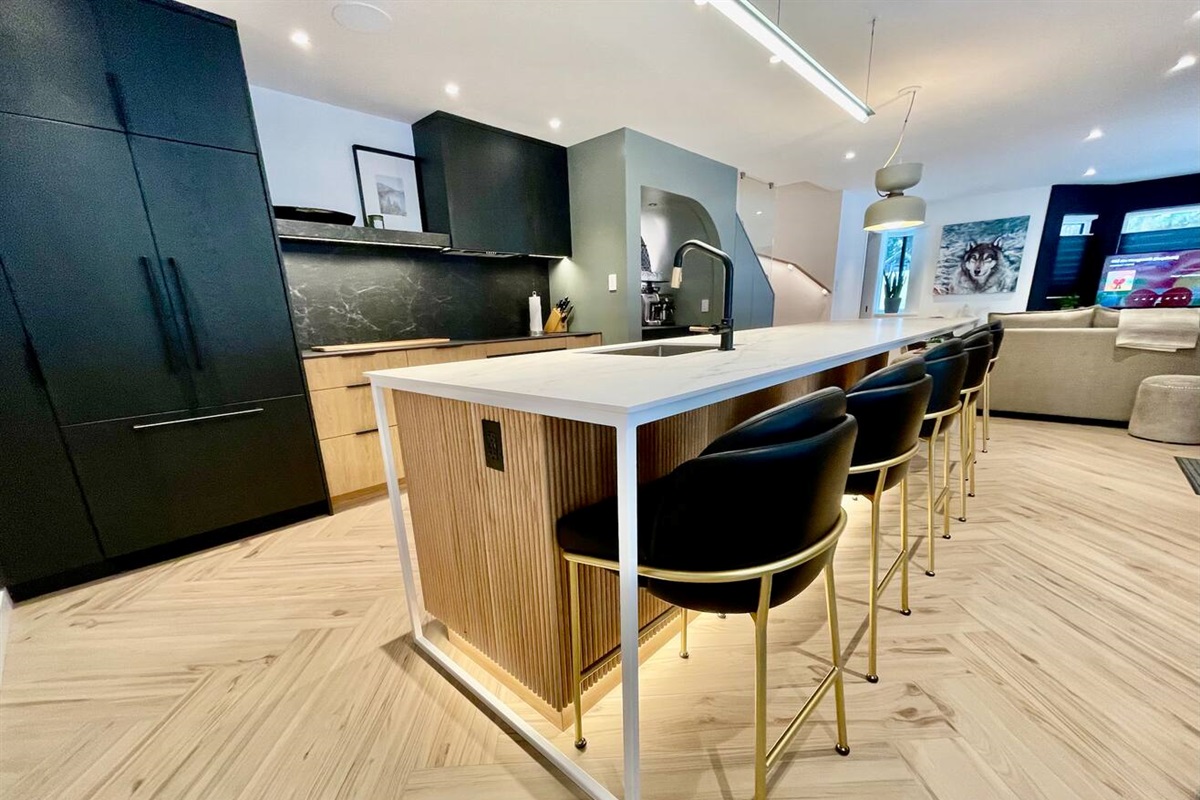 14ft kitchen island w/heated countertop & counter seating for 8 ppl. Fisher Paykel Refrigerator w/Icemaker, Induction cooktop, Convection oven & Dual DishDrawers dishwasher, drink fridge & coffee station, all integrated in custom oak cabinetry.