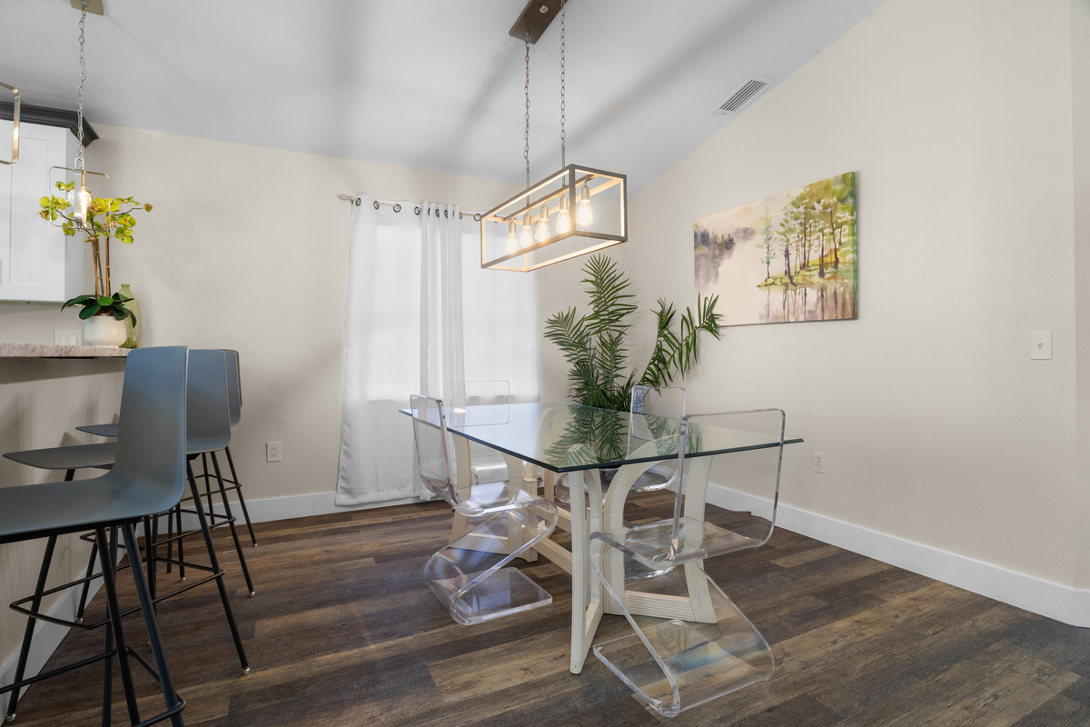 Dining room located near the kitchen breakfast bar stools.