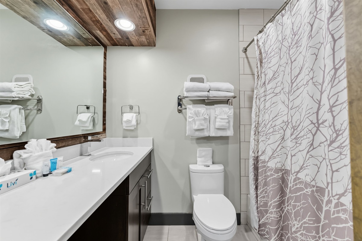 Full bathroom with two sinks, tub/shower