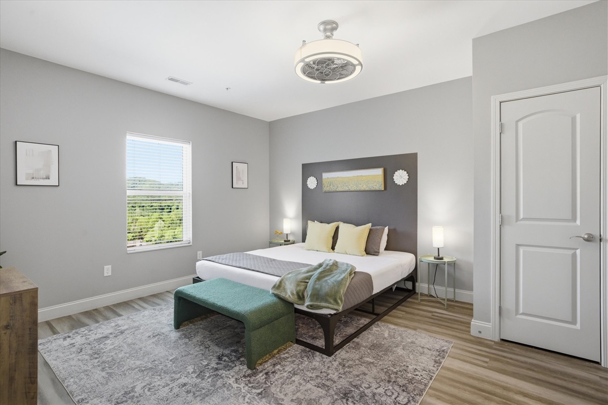 Unit 1’s primary suite keeps it simple and comfortable—soft bedding, a calm layout, and a TV for slow mornings or easy nights in.
