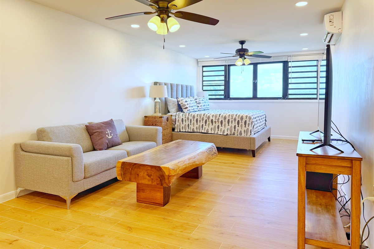 Continue down the hallway and you will enter the main living area with an AC unit to keep the whole place cool