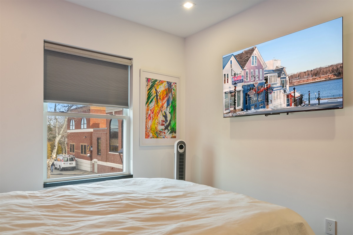 Enjoy total sleep control with true blackout blinds—essential for this sun-drenched east-facing room. Features a 55-inch Roku Smart TV and modern oscillating fan, ensuring a cool, dark, and entertaining retreat in downtown Bar Harbor.