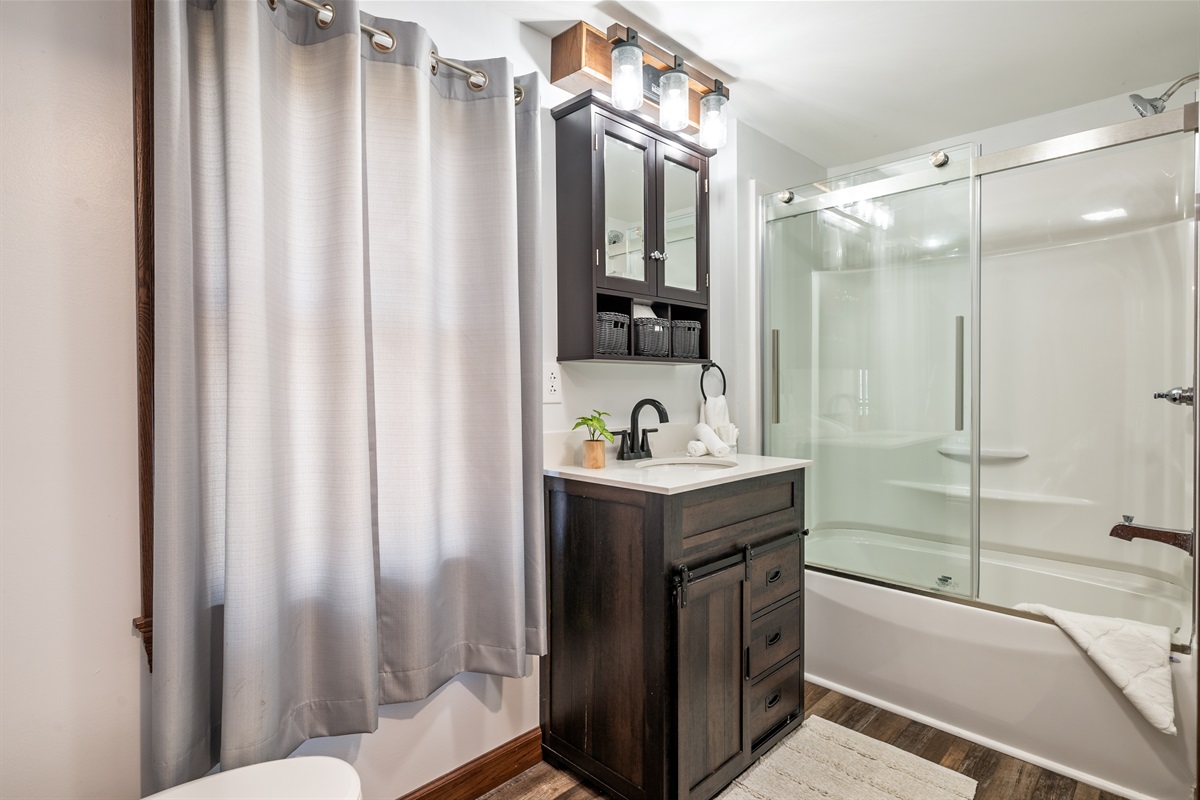 Modern bathroom with walk-in shower, elegant vanity, and soft lighting—your private spa experience after a day on the lake.