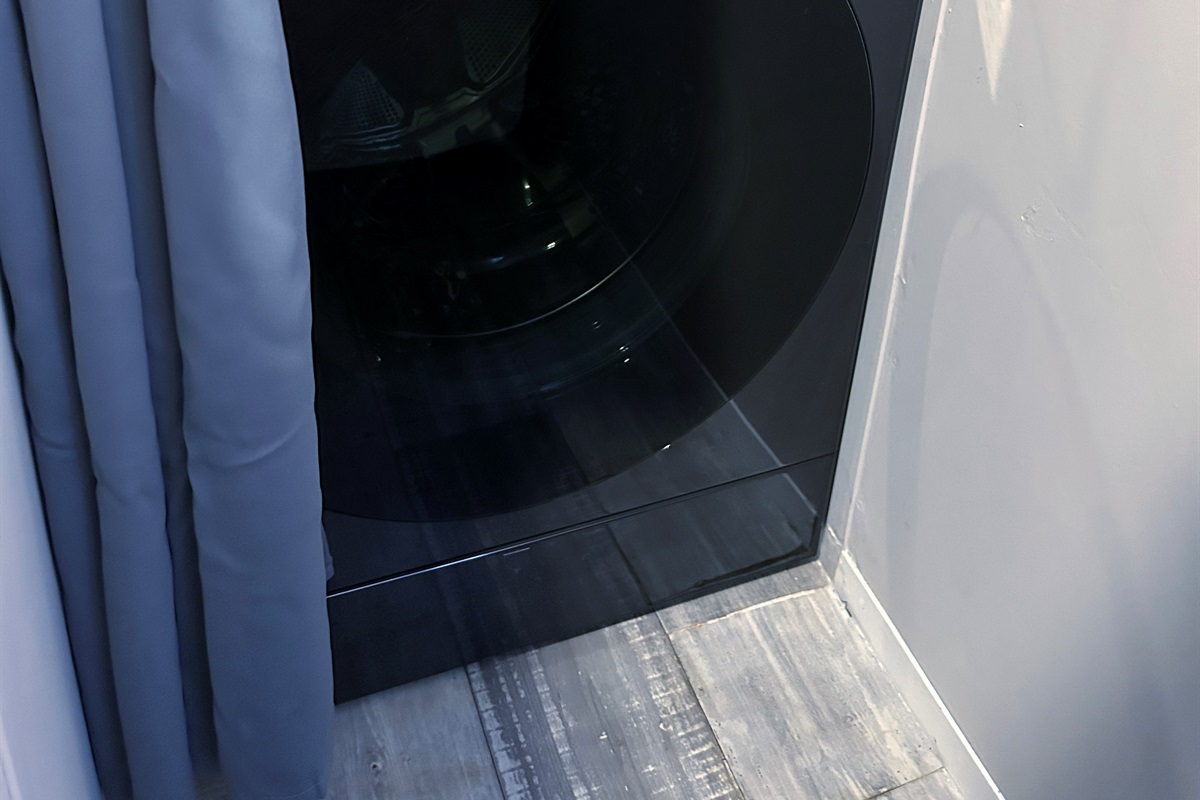 Washer/dryer combo hidden in bedroom 1 closet