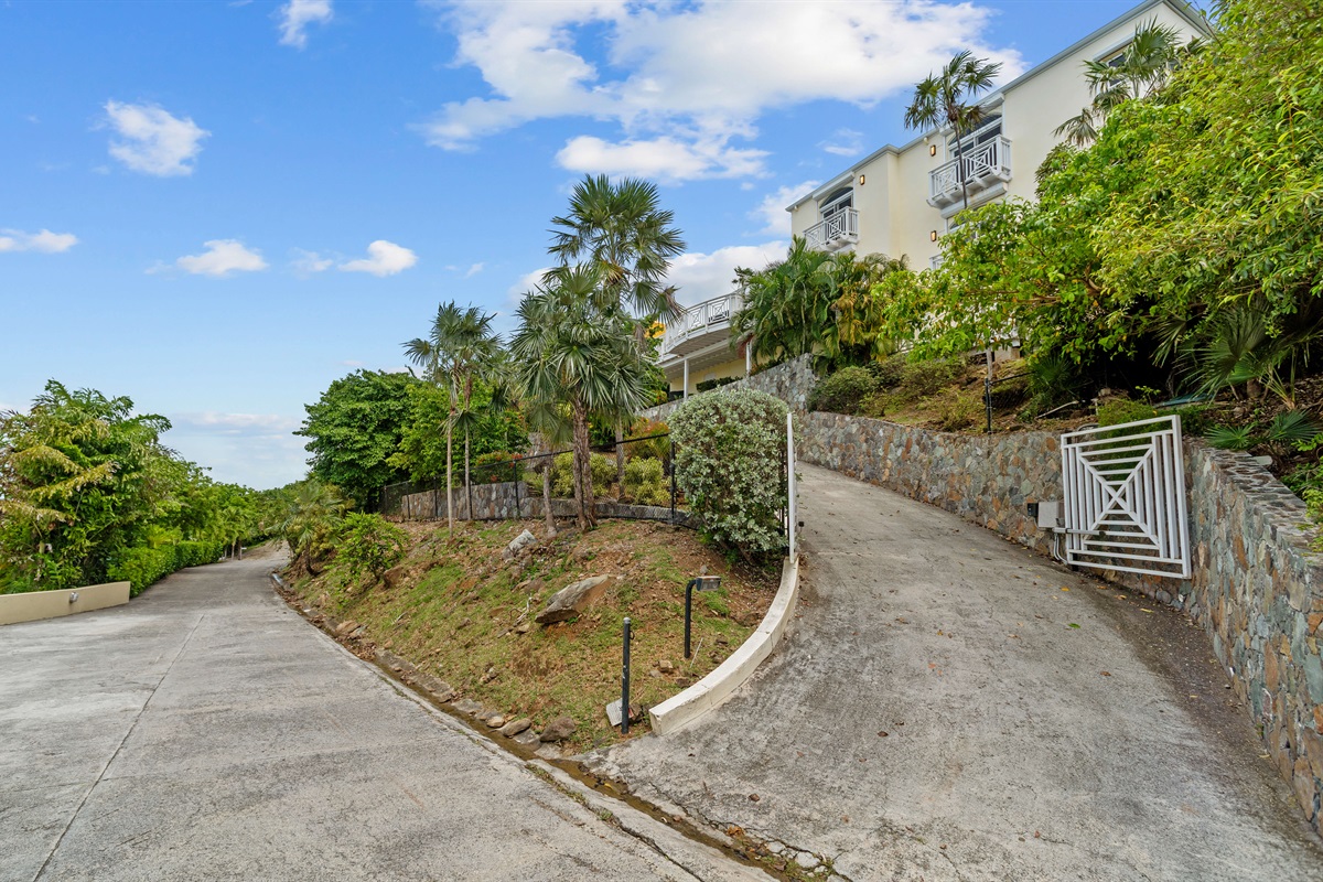 Charming island villa exterior with tropical plants and free parking. A beautiful welcome, every time.