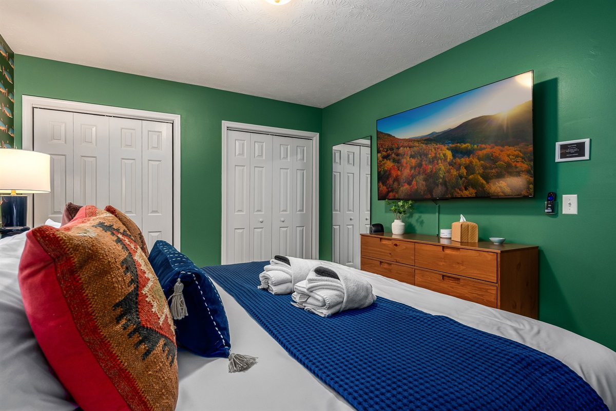 Relax, stream a movie, and unwind in this cheerful forest-themed bedroom.