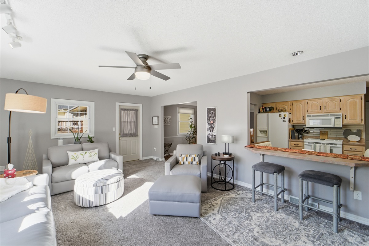 With casual barstool countertop seating and plush couches in a sun-filled den, there is plenty of space for the family to come together.