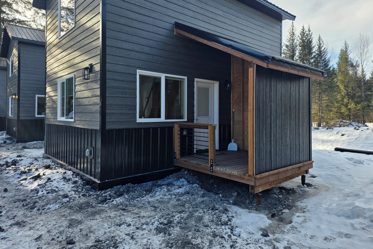 Cabin entrance with covered porch area.  There will be steps added to the porch and a freezer on the porch.