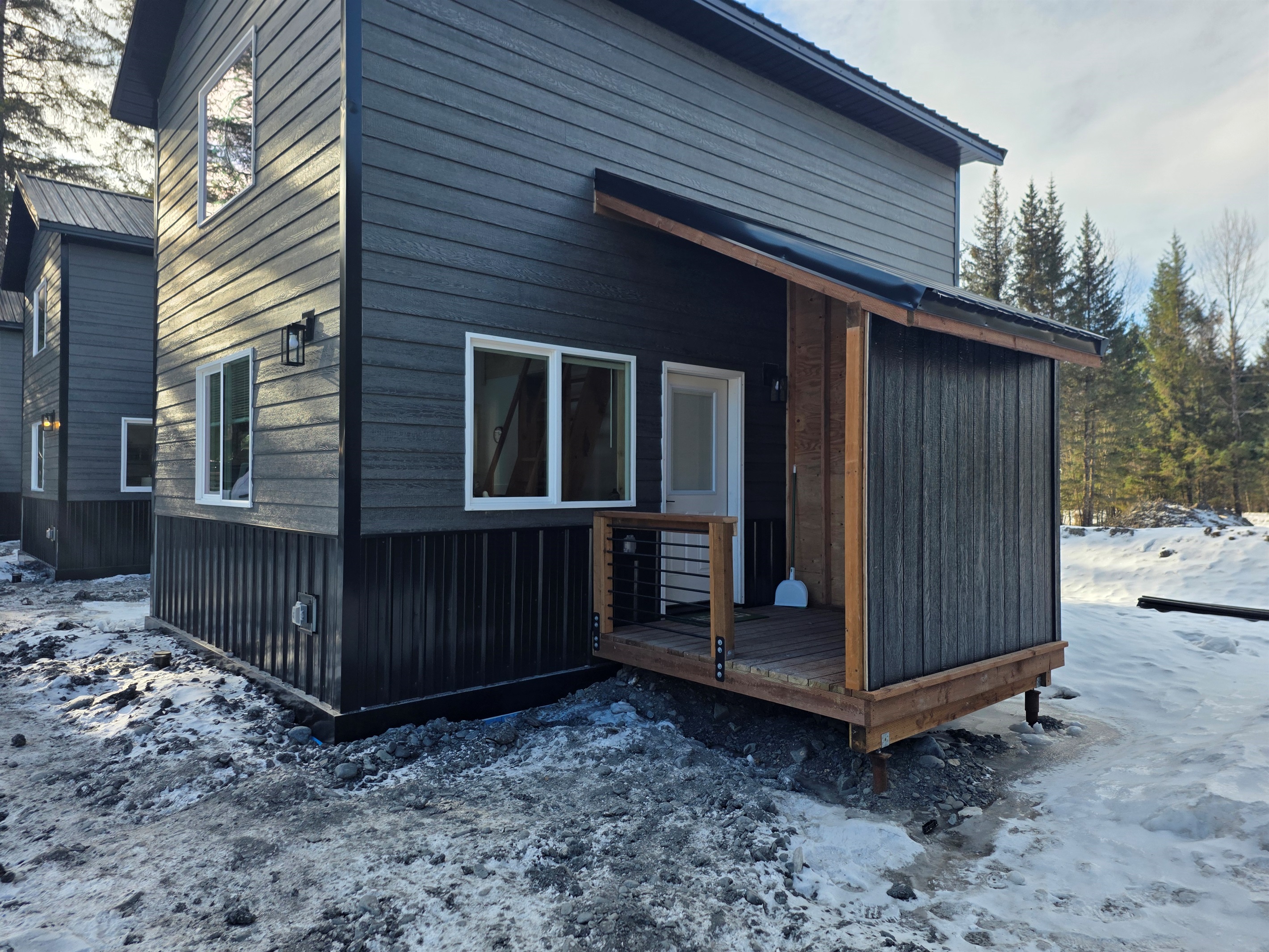 Cabin entrance with covered porch area.  There will be steps added to the porch and a freezer on the porch.