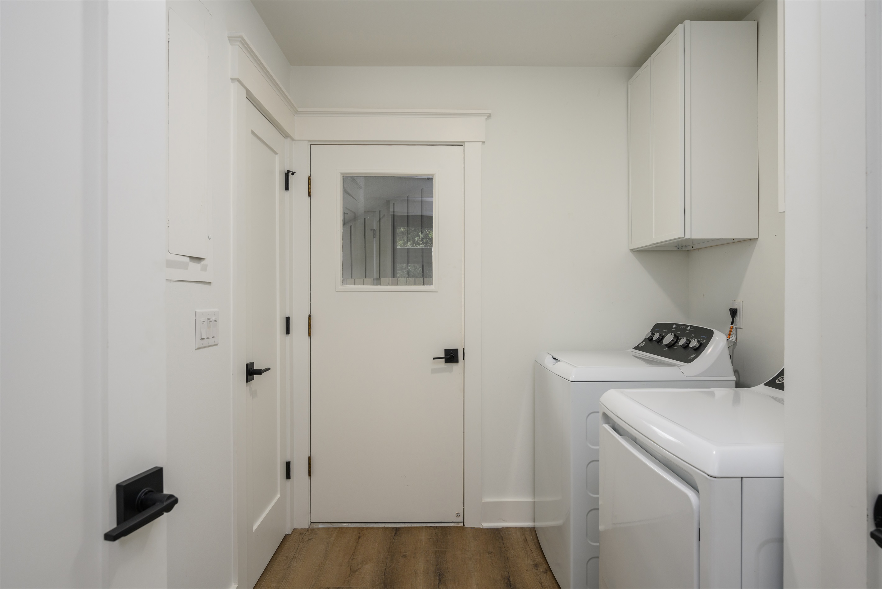 Laundry room features ful size washer and dryer; exit to carport and utility yard