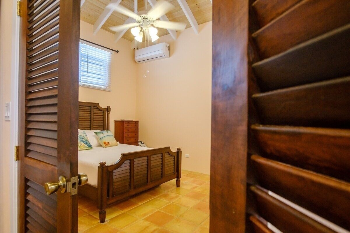 Down a few stairs is the bedroom with air conditioning.