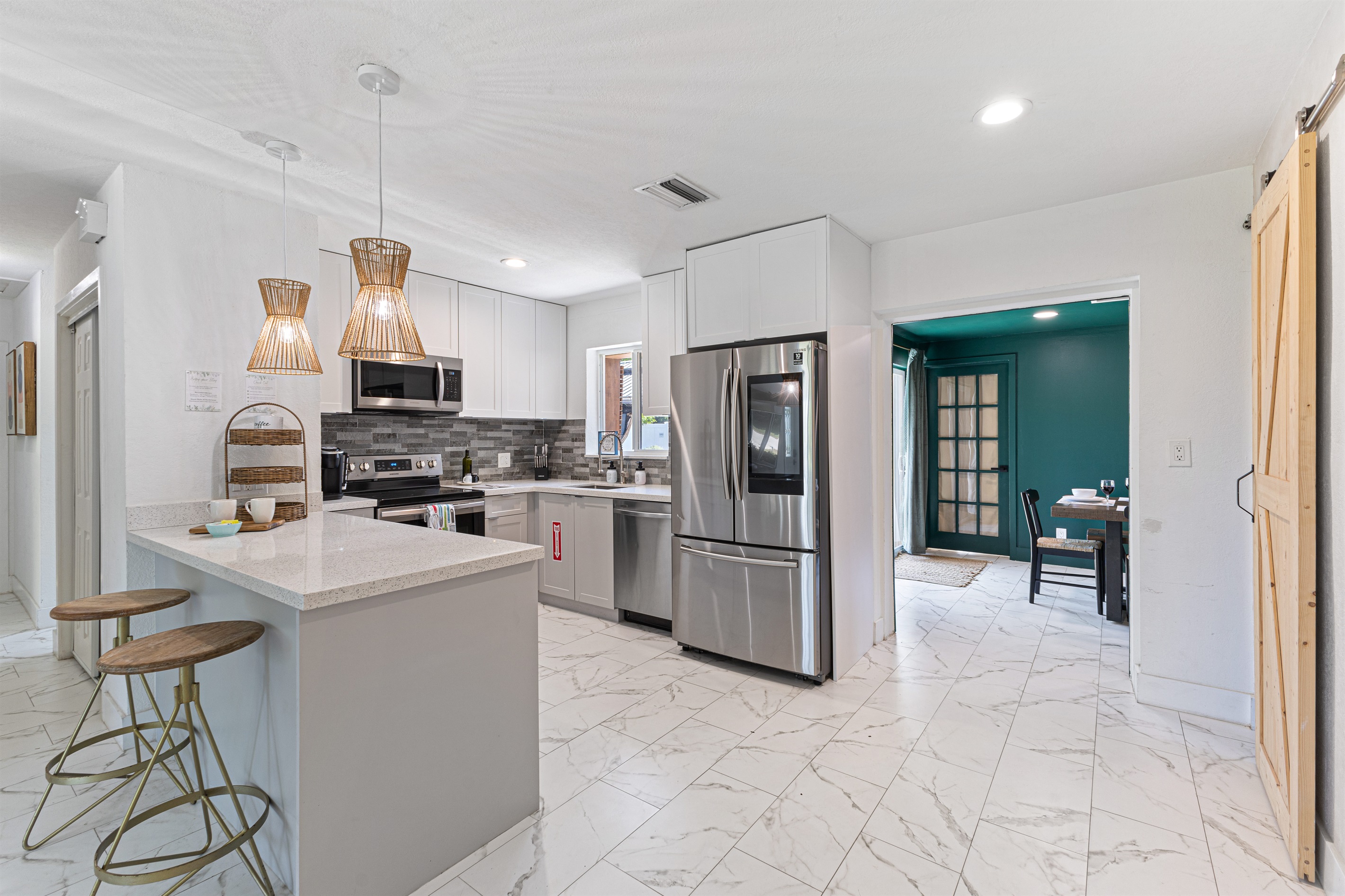 Fully equipped kitchen — stainless appliances, Keurig, and filtered water.