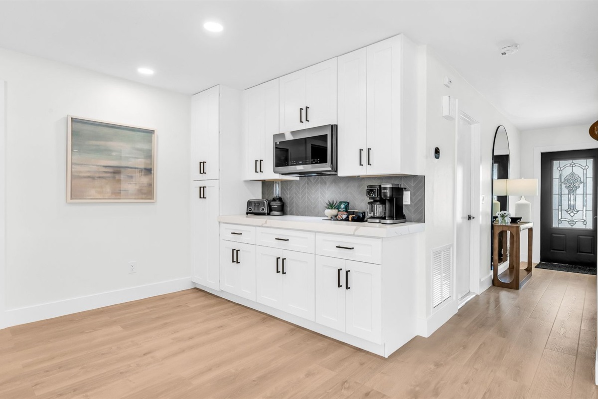 This fully renovated kitchen is the heart of the home, featuring a stunning quartz waterfall island, sleek white cabinetry, and brand-new stainless steel appliances. Perfect for cooking, entertaining, or simply gathering with loved ones