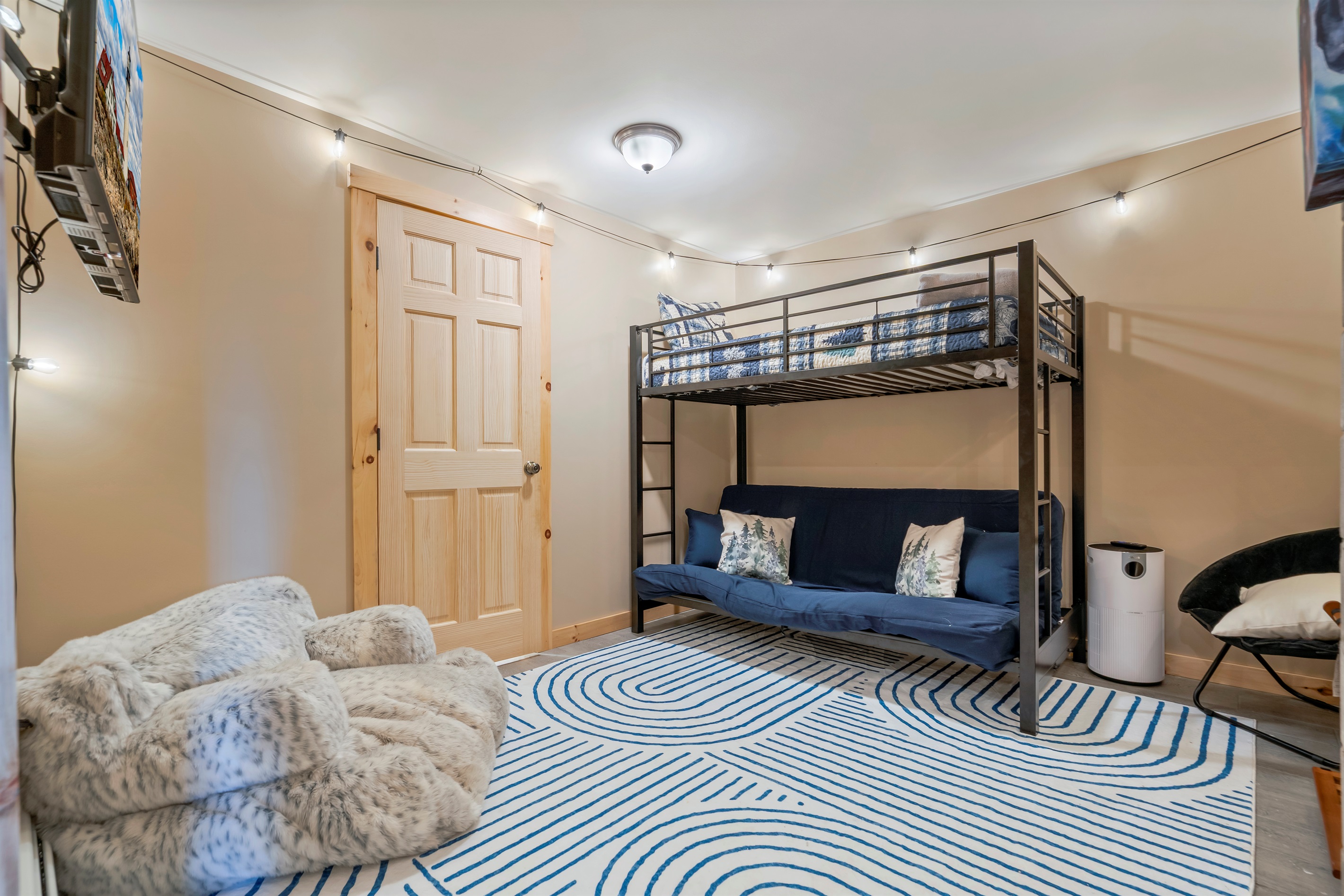 The adjoining room features a cozy twin loft bed and a trundle