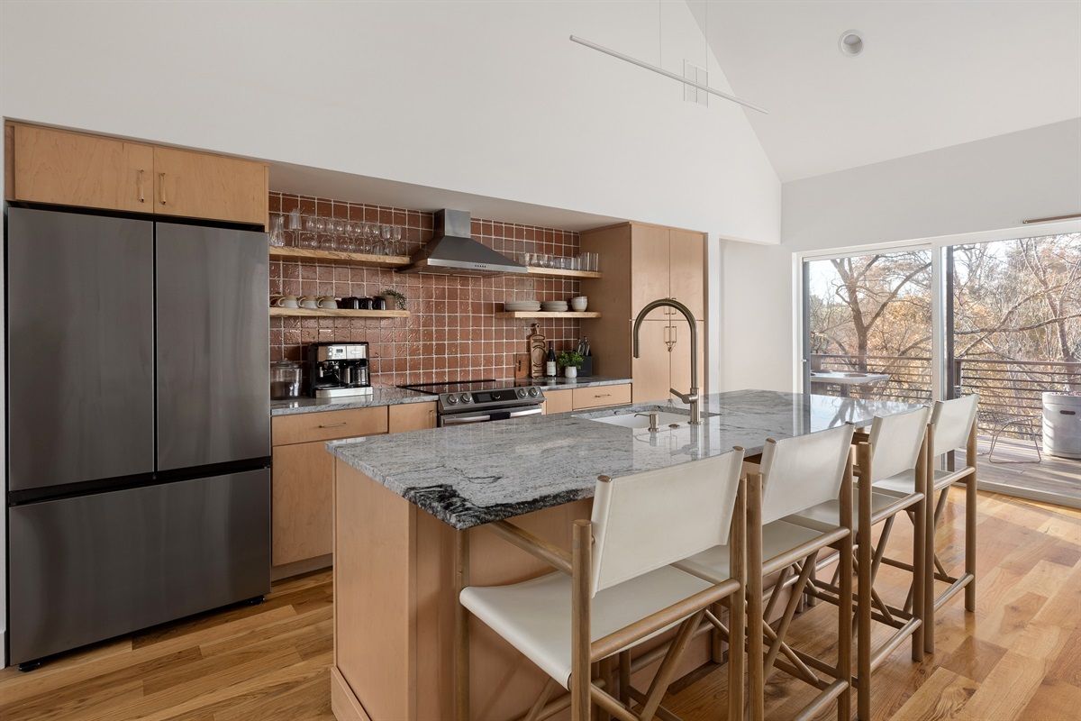 {Kitchen - Gallery House} A chef-inspired kitchen with a quartz island, stainless appliances, coffee bar, and seating for effortless mornings together.