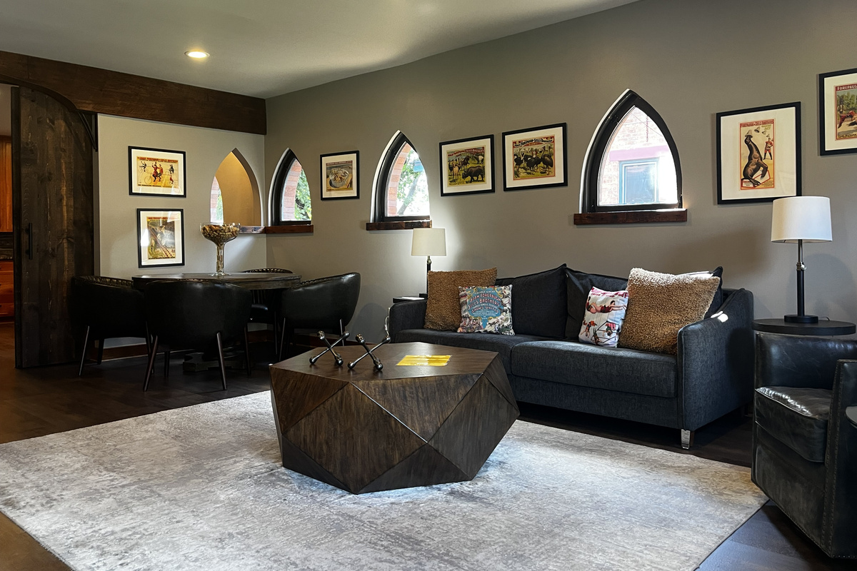 Living and dining area with the King sleeper sofa and vintage circus posters
