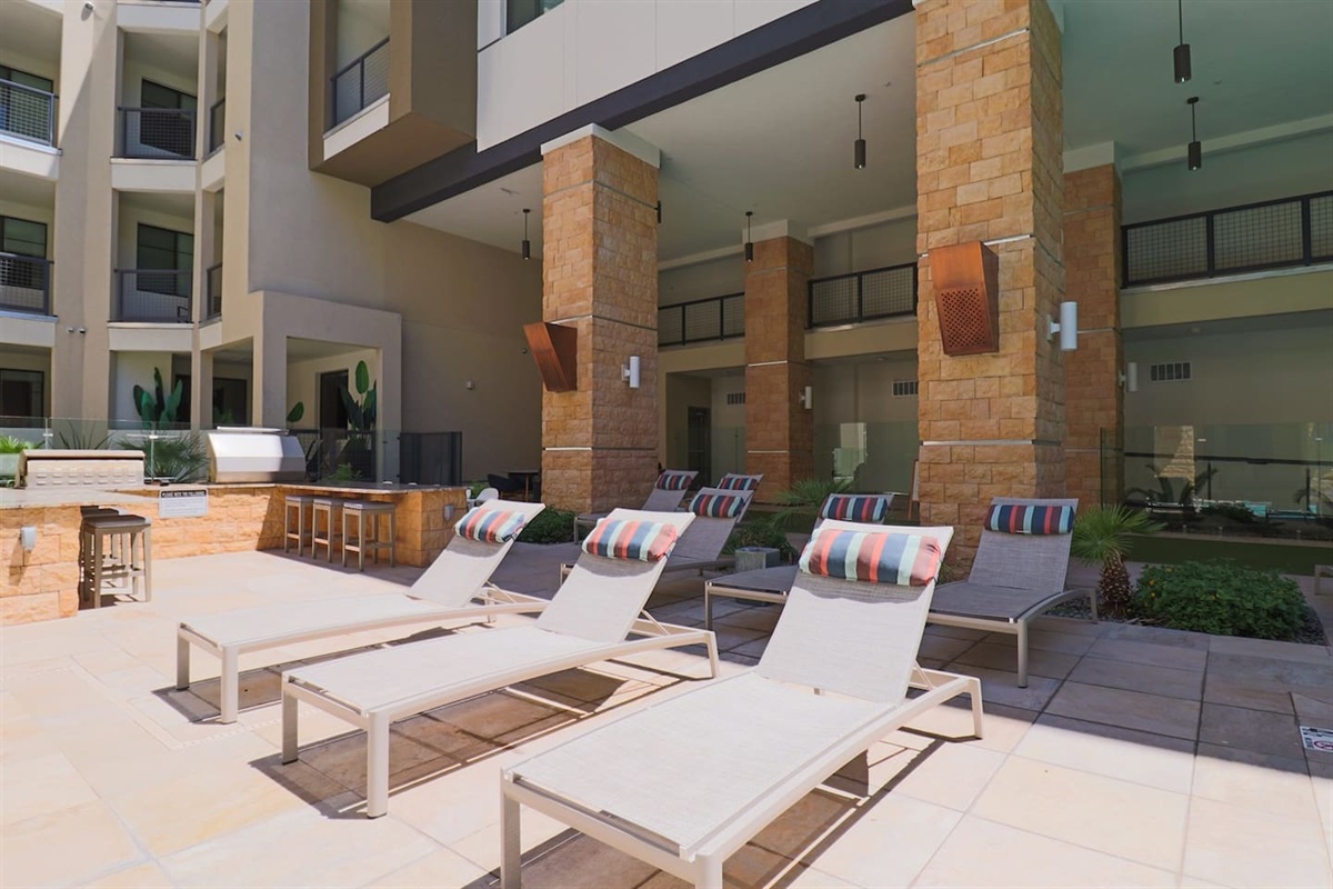 - Soak up the sun on poolside loungers with stylish cushions and open views   - Relax near the outdoor BBQ area for a refreshing, laid-back afternoon   - Ideal for tanning, reading, or simply enjoying the peaceful poolside air