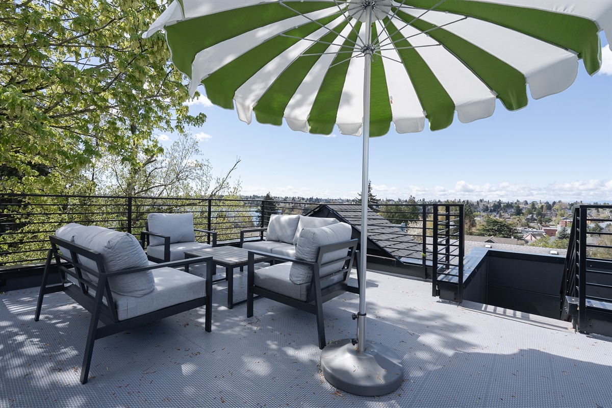 Enjoy expansive views from our panoramic rooftop deck! Imagine enjoying a meal or drinks with friends & family with the mountains in the distance!