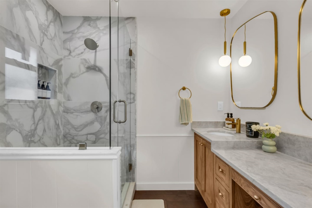 Guest full bathroom featuring a spacious walk-in rain shower and an oversized single-sink vanity for added comfort and convenience.