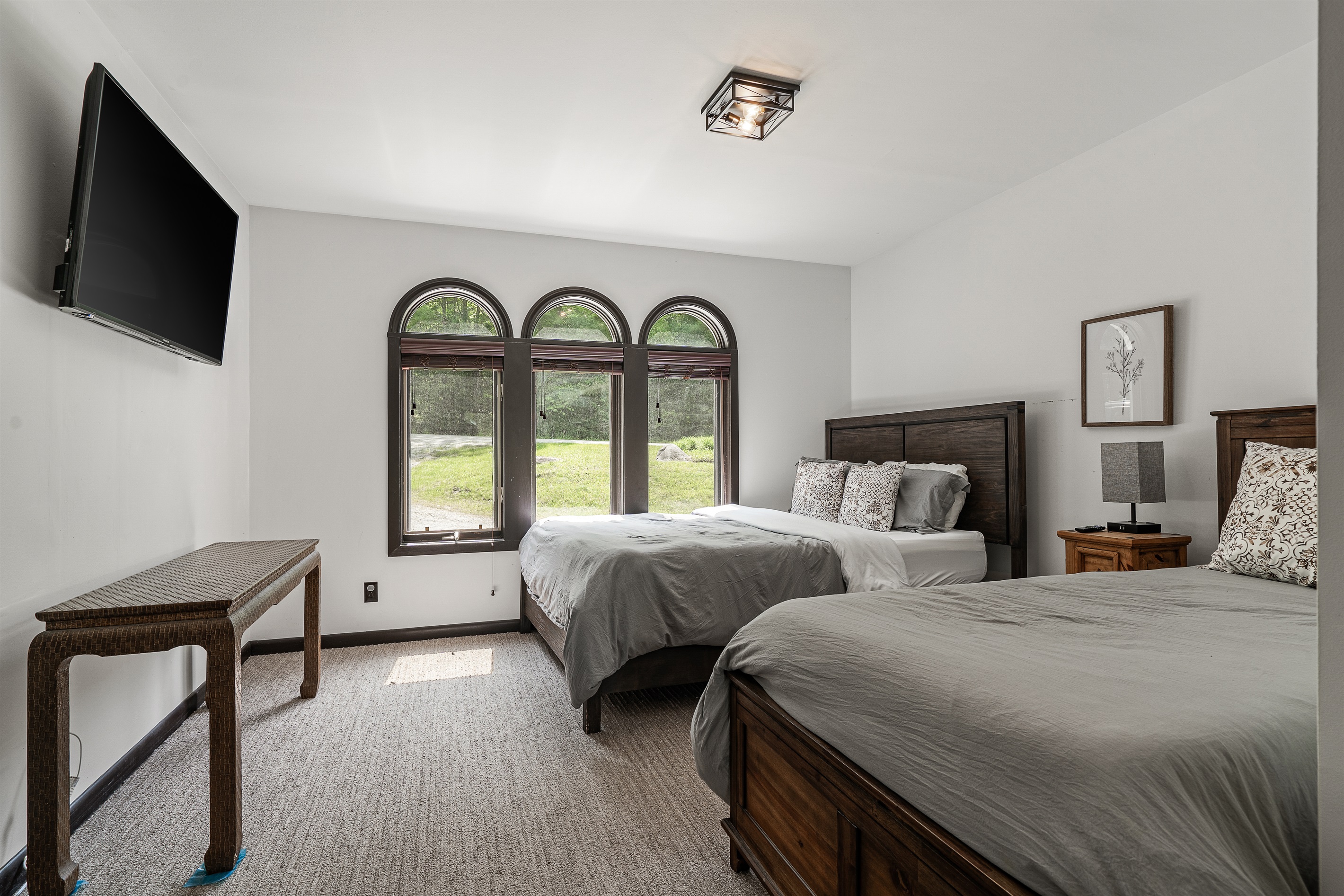 Main floor bedroom with queen and twin beds