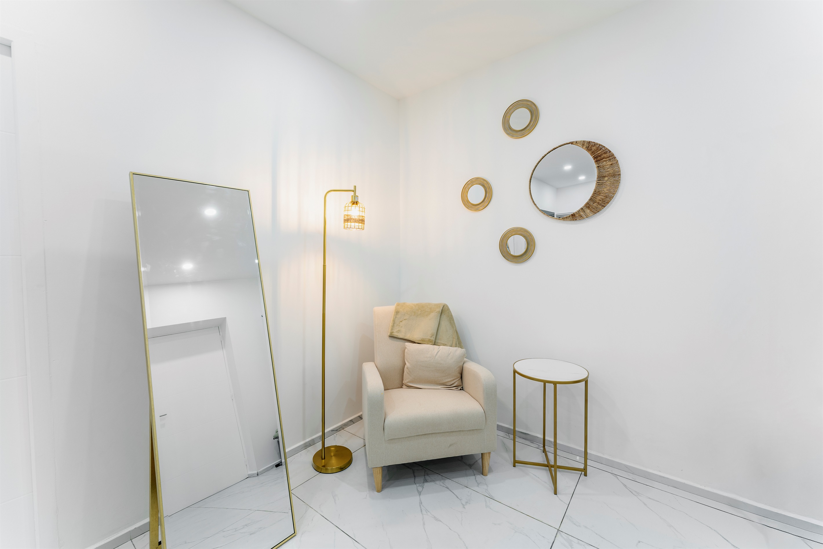 Cozy reading corner with chair, floor lamp and mirrors (bedroom 2)