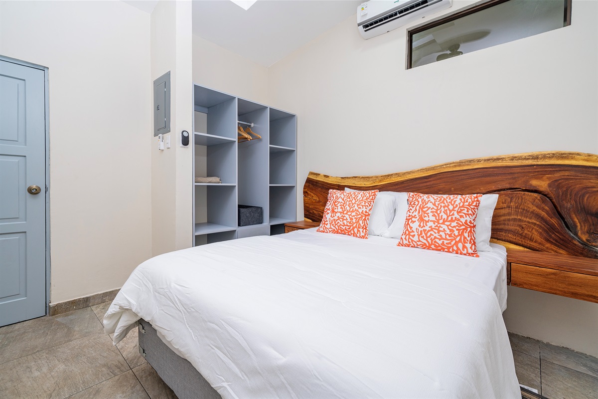 The guest bedroom has a queen bed and ample closet space, air conditioning & ceiling fan