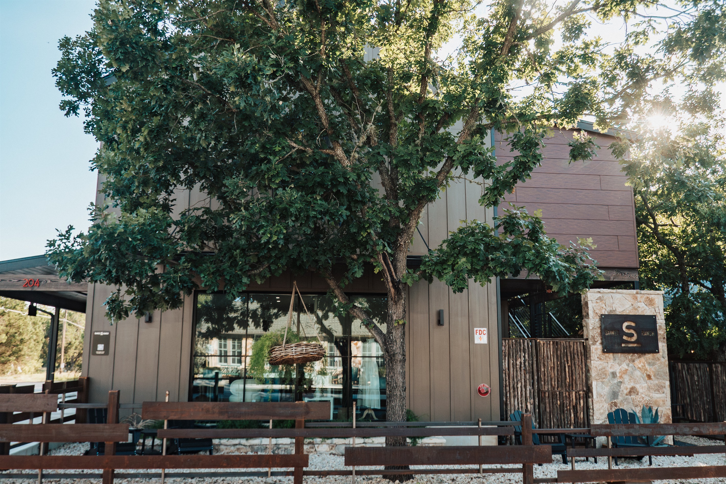 Gaines Ranch on the Square — shaded by Hill Country oaks and walkable to downtown Wimberley, with the Homestead Suite offering full ADA accessibility on the ground floor.