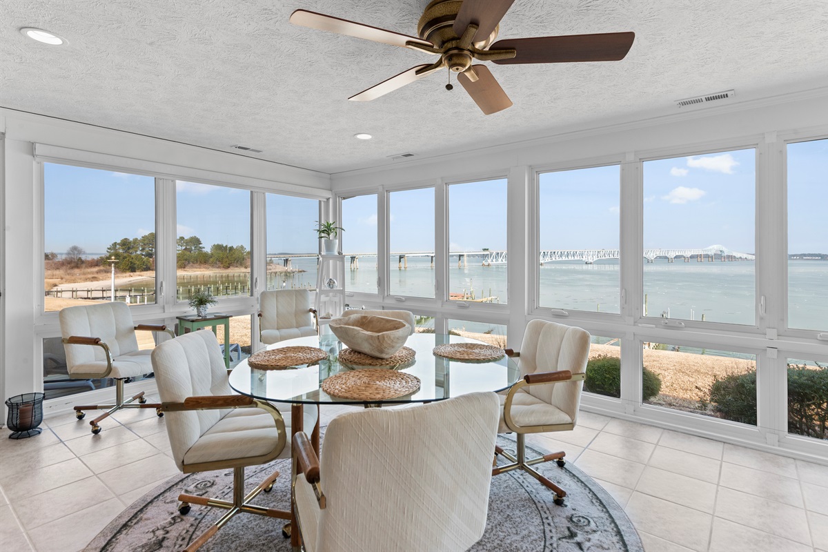 Sunroom Retreat: Bask in stunning waterfront views while enjoying meals and relaxation here!