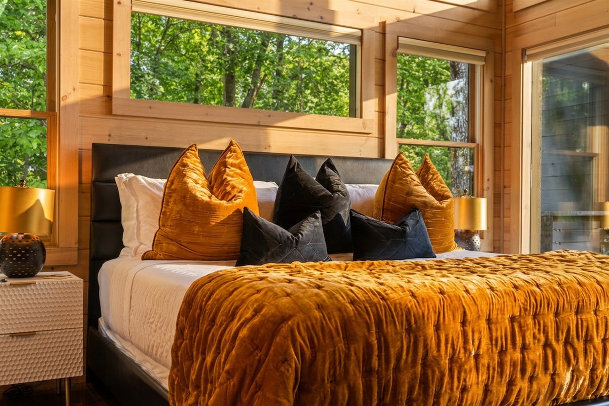 Oversized windows fill the space with natural light and breathtaking outdoor views by day, with pull-down curtains for cozy privacy at night.