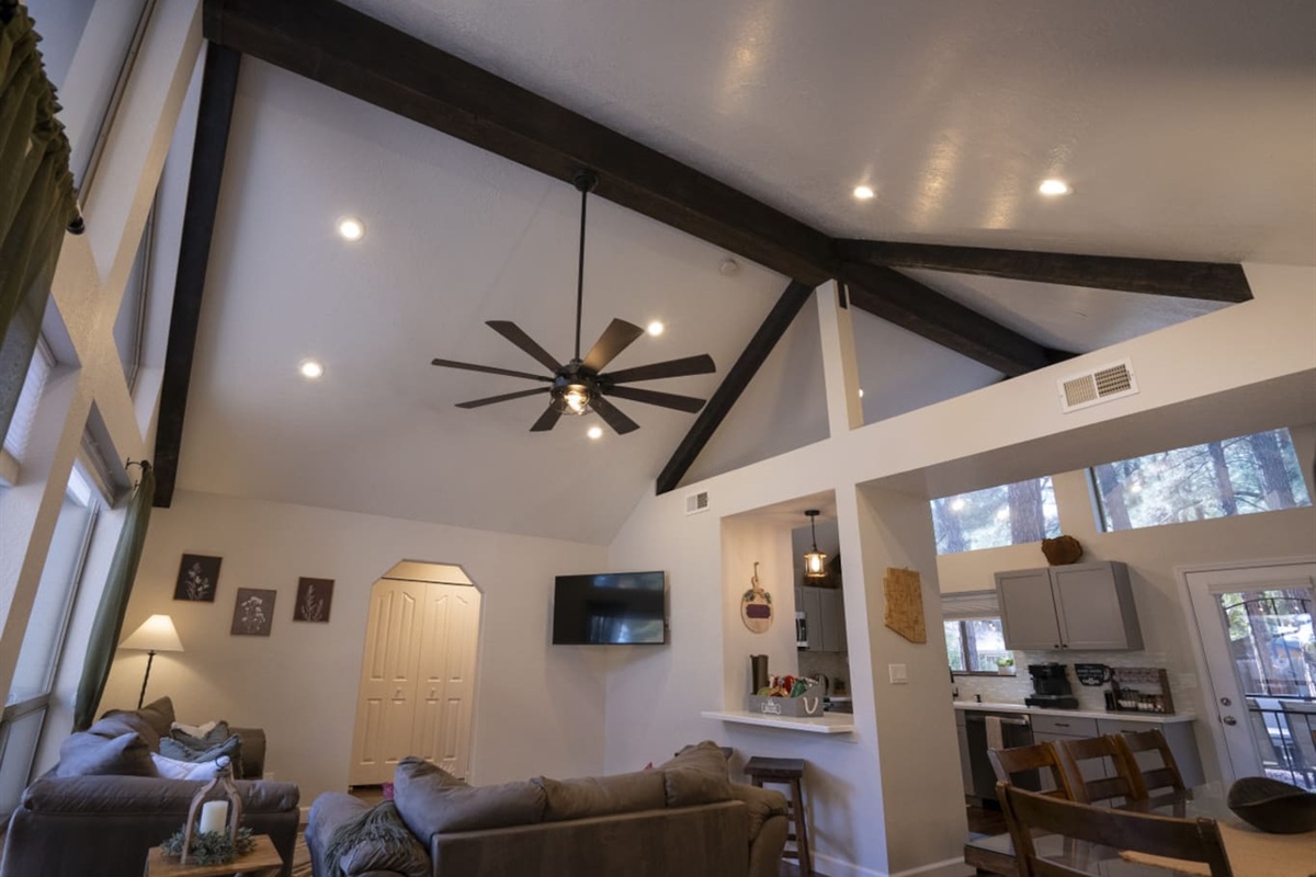 Open living space with tall windows, natural light, and a cozy setup for gathering after a day out.