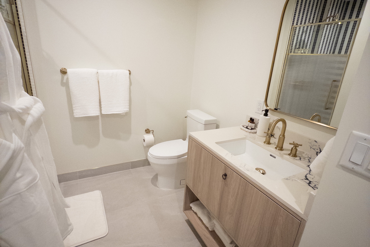 Designer bathroom - custom tilework, glass shower and a sculptural vanity.