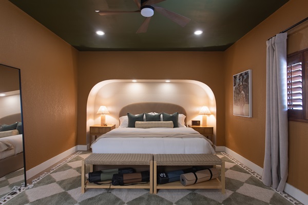 This King suite blends vintage golf clubhouse charm with modern wellness touches—ensuite bath, yoga mats, desk, and a full-size mirror make it perfect for a solo stretch, quick email, or quiet retreat