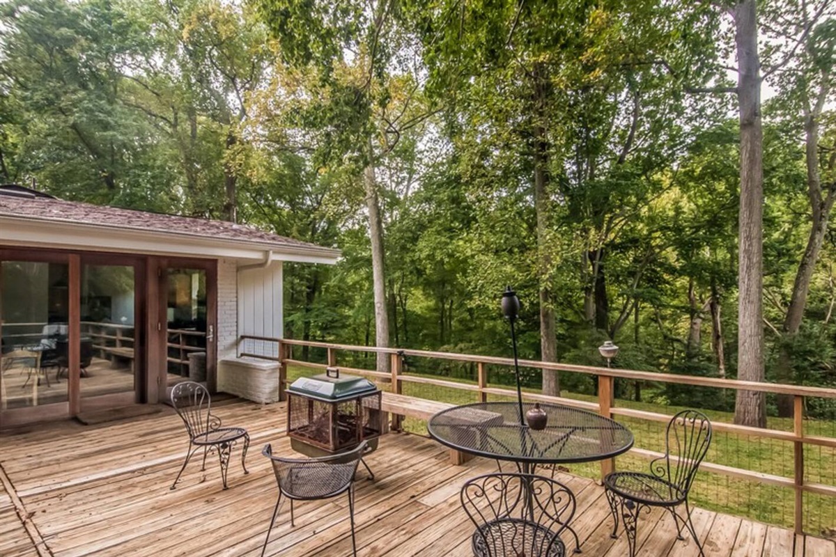 Back deck with grill, outdoor seating and dining, and firepit. Overlooks the backyard and the creek below.