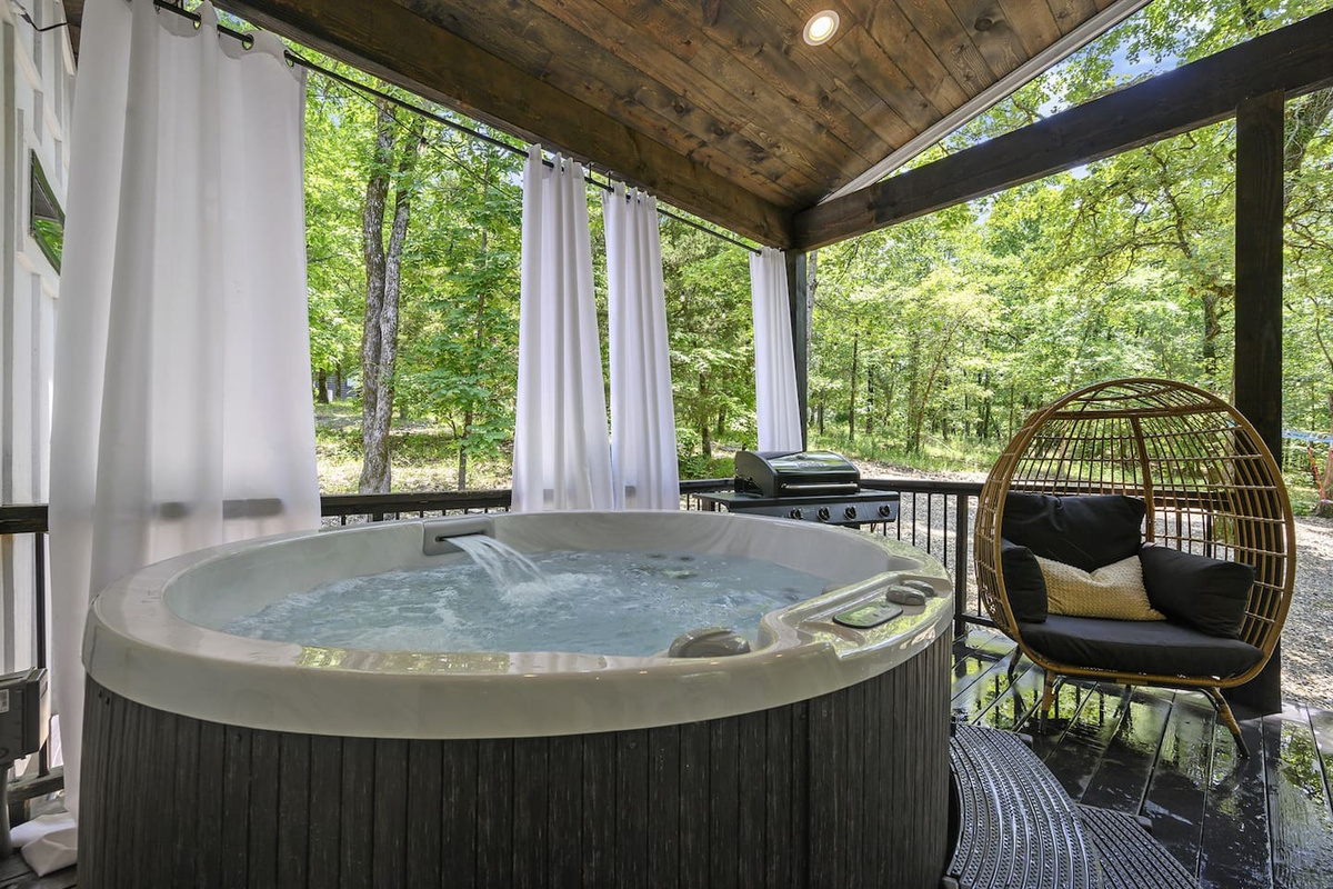 Unwind in your private hot tub surrounded by lush trees and nature's beauty!