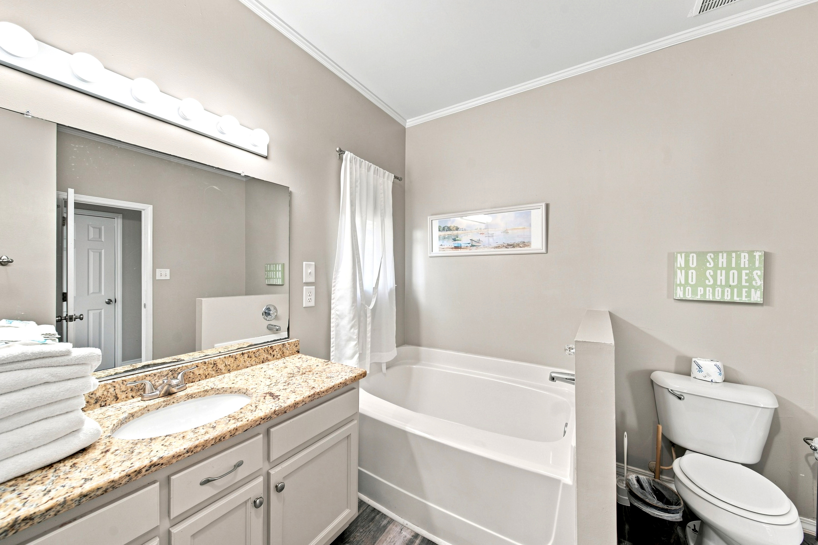 Soak away the day in the primary suite's private soaking tub, part of the spacious en-suite bath.