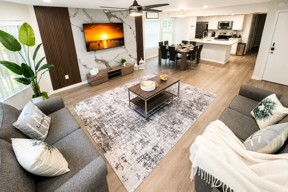 Spacious open-concept living area with comfortable seating and a TV.