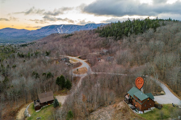 This aerial view reveals the beauty of the home nestled in nature’s embrace.