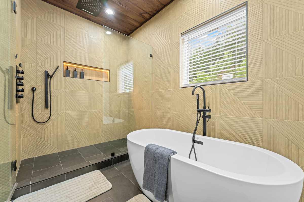 master bathroom with soaking tub and waterfall shower head