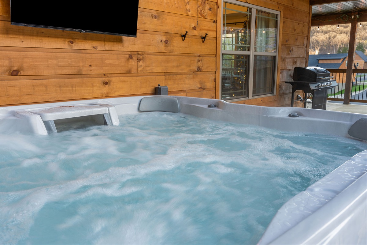 Relax in the hot tub while enjoying the outdoor setting.
